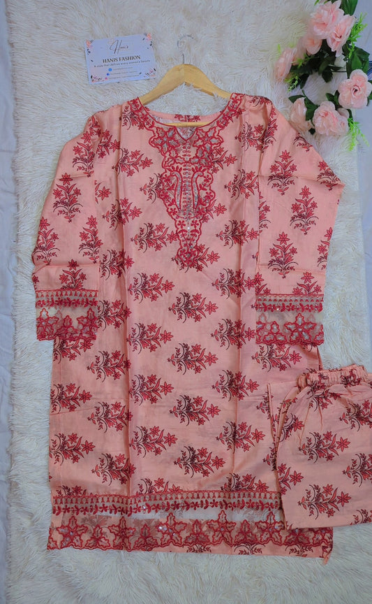 Pink embroidered kurta with matching pants on a hanger against a white background.